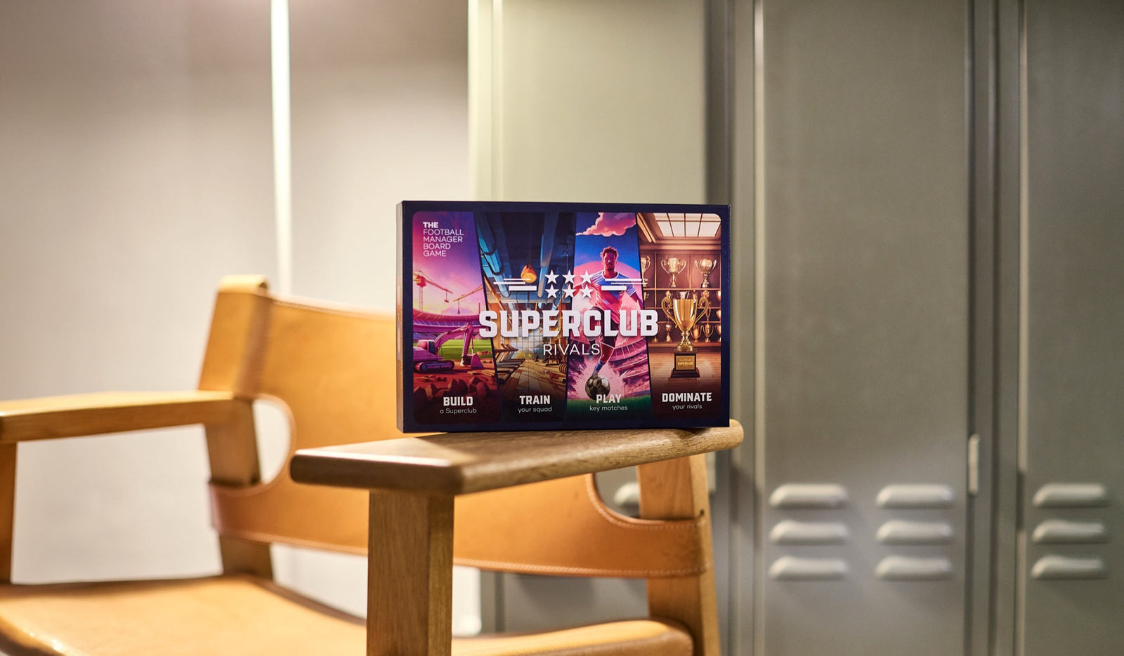 Superclub Rivals – the football manager board game box on a chair in a locker room, now available